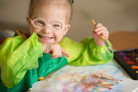 child with special needs painting