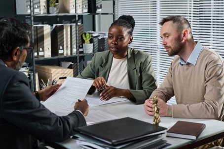 couple reviewing documents with a lawyer